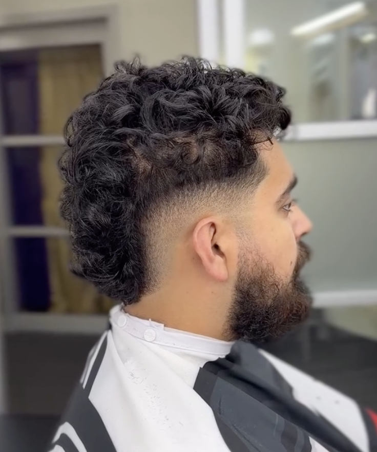 Curly mullet with low taper and beard
