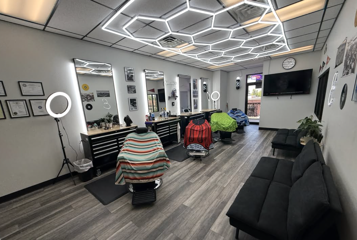 Interior of Elegance Barber Studio with vintage chairs and warm lighting