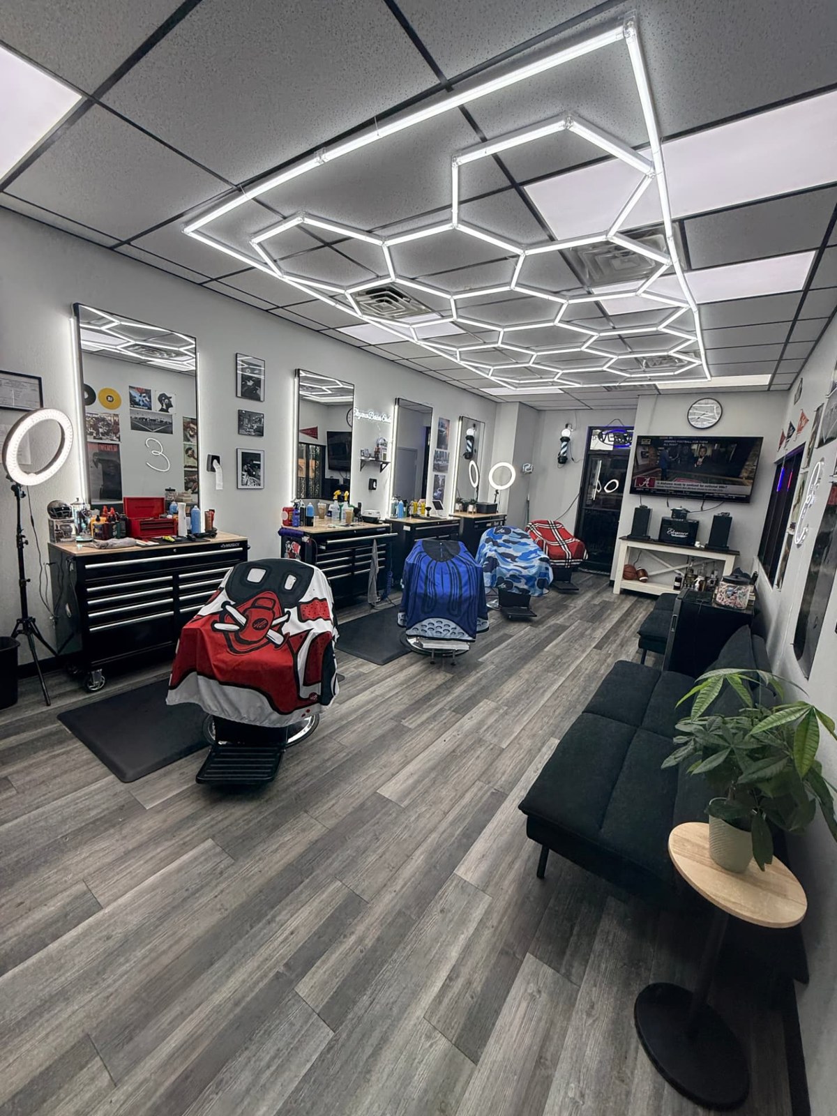 Interior of Elegance Barber Studio with vintage chairs and warm lighting